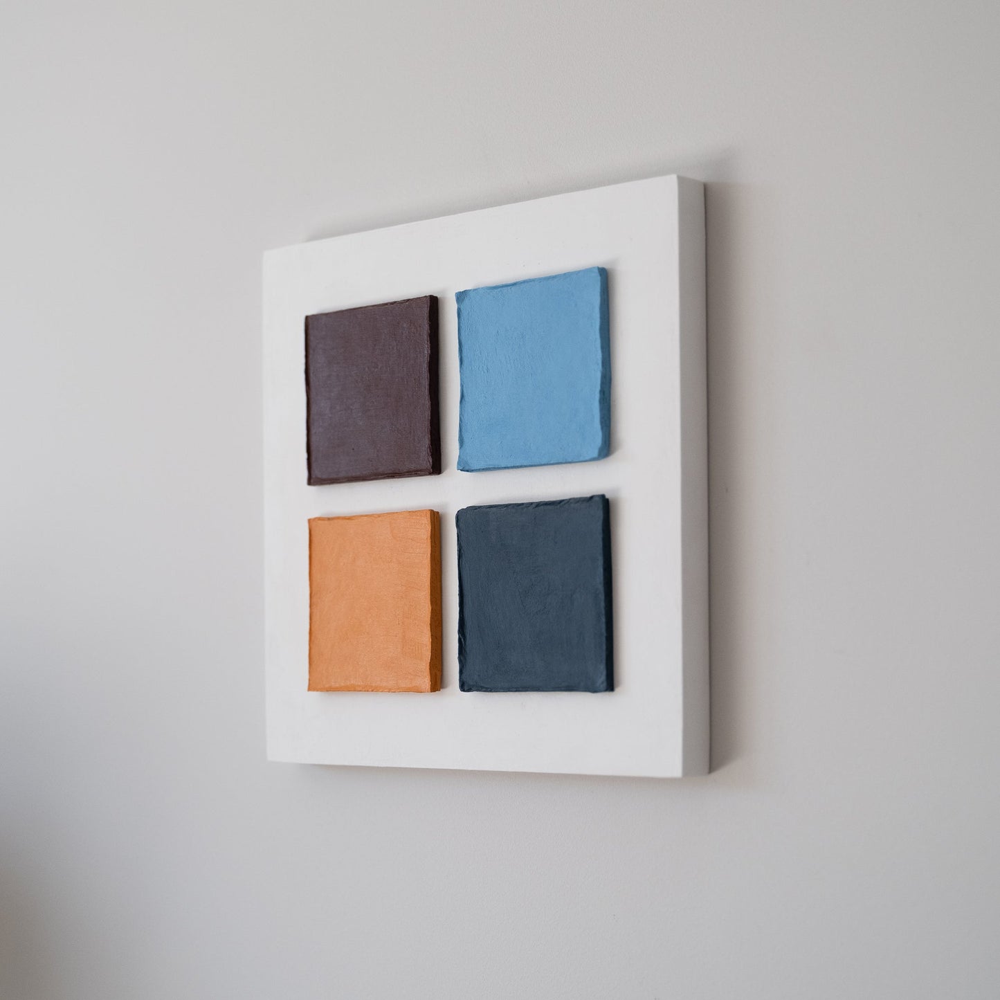 Side view of geometry style wall art Four Squares in Exile – Textured Cardboard on the wall