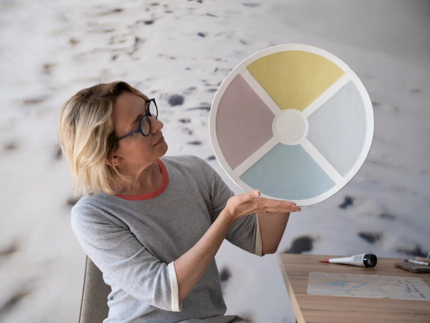 Morning Color Wheel, a round pastel relief, held up in the studio